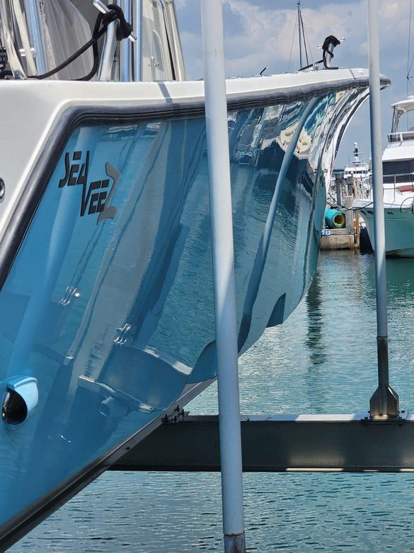 SeaVee hull polished to a mirror gloss alongside a Miami dock