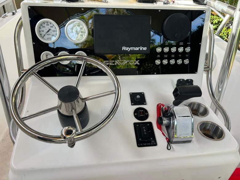 Sea Fox center console helm with a Raymarine multifunction display, analog gauges and a custom backlit switch panel