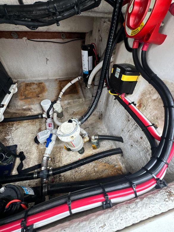Bilge compartment with washdown pump, sea chest plumbing, battery switch and protected battery cabling